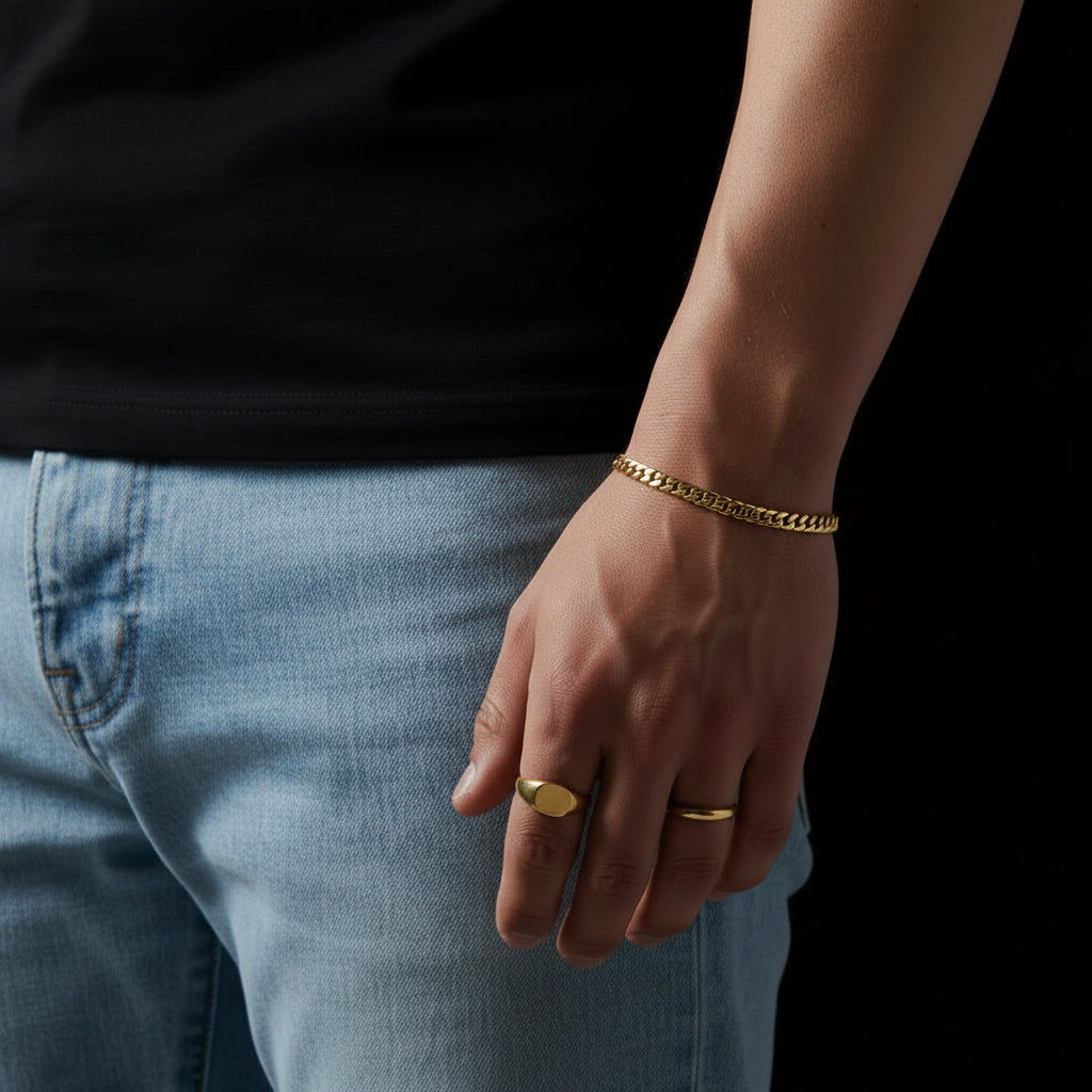 Gold chain bracelet on a wrist with a blurred background